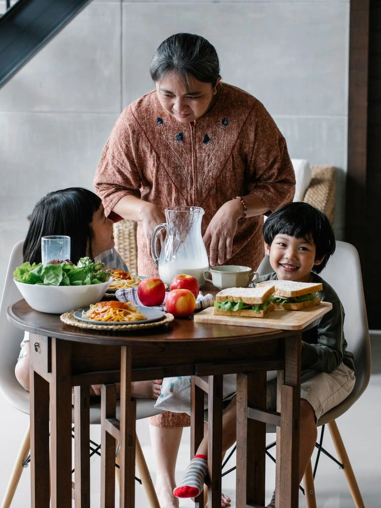 A small modern cold-press inside the family mill, fresh green olive paste